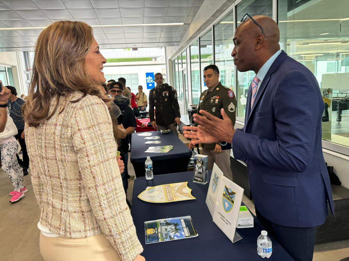 Congresswoman María Elvira Salazar speaks with a group of attendees and employers at  job fair. This year, the job fair organized by her office comes at a difficult time for Floridians, who are facing an unemployment rate higher than the national average.